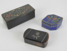 A papier mache lidded pin box with hand painted design to lid, 9cm in length,