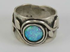 An Arts and Crafts black opal ring, indistict mark within,