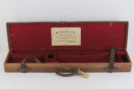 A 12 gauge leather shotgun case having carry handle and twin straps, marked EP,