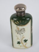 A porcelain hand painted and gilded perfume bottle having HM silver screw on lid,