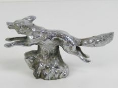 A silver plated car mascot bonnet ornament by Lejeune in the form of a running fox, with screw stud,