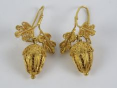 A pair of 18ct gold filigree earrings in the form of oak leaves with acorn suspended below,