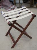 A 'X' framed mahogany suitcase stand with canvas straps, 63cm high.