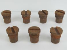 Seven 105mm shell transit plugs.