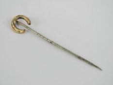 A horse shoe stock pin or tie pin, yello