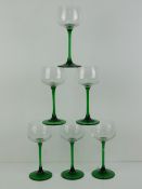 A set of six green stemmed hock glasses.