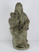 A precast stone garden ornament figurine