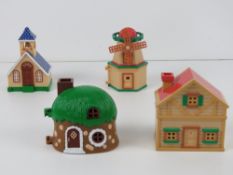 Four Sylvanian Families miniatures being two houses,