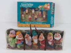 A set of Seven Dwarves figurines from Disney's Snow White in original packaging,