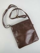 A brown leather handbag with label for Alpha 8