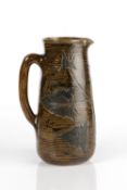Robert Wallace Martin at Martin Brothers jug, decorated with holly leaves, inscribed 'R W Martin,