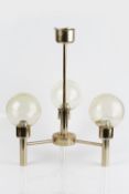 Contemporary three branch ceiling light with gold lacquered finish, spherical shade with amber hue