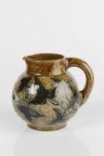 Martin Brothers globular jug, decorated with ivy leaves and flowers, incised 'Martin, London,