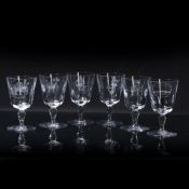 Group of five Baccarat of France wine glasses variously etched, including coat of arms, oval