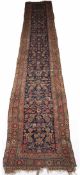 Wool runner Caucasian, with blue central rectangular panel within a multiple border, 497cm x 93cm