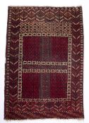 Red ground Turkoman rug with central square panel and geometric designs, 109cm x 155cm