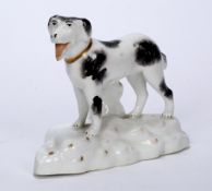 English porcelain model of a Newfoundland dog circa 1845, standing upright on a rocky bed, 9.5cm