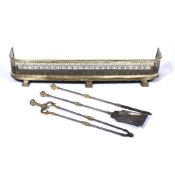 Set of three brass and steel fire irons 19th Century, and a brass fender, 19th Century, fender