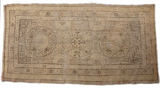 Khotan rug Chinese with stylised circular medallions, 254cm x 122cm