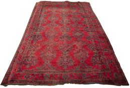 Large red ground Ushak carpet Turkish with traditional rows of geometric designs in blues and