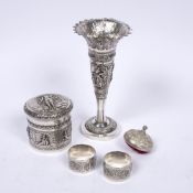 White metal tapering vase Burmese embossed with panels of figures, 19cm high, a cylindrical