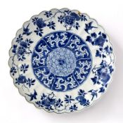 Blue and white dish Chinese, Kangxi period (1662-1722) with a shaped border, the centre decorated