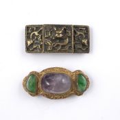 Two belt buckles Chinese the first with gold metal backing with two inlaid jade coloured stones