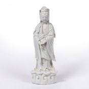 Blanc de chine standing figure of Guanyin Chinese, early 19th Century heavily potted, on a wave