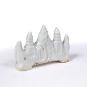 Blue and white glazed brush rest Chinese, Qing dynasty moulded with a mountain peak and pagodas, 7.