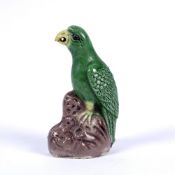 Porcelain miniature model of a green glazed parrot Chinese, 19th Century Kangxi style, with yellow
