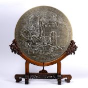 Bronze circular plaque Chinese, circa 1900 depicting warrior figures at the entrance of a fort, on a