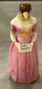 A Royal Worcester candle snuffer as a singing bird headed woman 