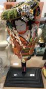 A modern Japanese fabric covered and painted bat depicting a geisha,