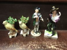 A collection of Continental porcelain figures including a pair of Canaries, 11 cm high,