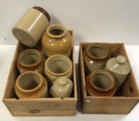 Two wooden wine crates containing various stoneware storage jars,