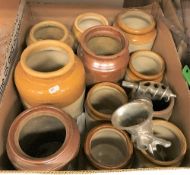 A box containing various stoneware storage jars and a box of assorted kitchenalia,