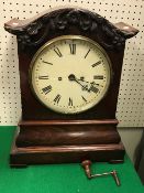 An early Victorian mahogany cased mantel clock with oak leaf and acorn decorated cornice over the