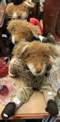 A set of three door stops as foxes in hunting attire,