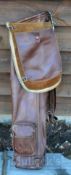 Good period leather oval shaped golf bag c/w leather shoulder strap, travel/accessory hood, and ball