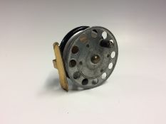 Scarce Crossle Patent 3” alloy, wood, ebonite and brass reel with a brass star back, perforated