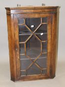 A modern walnut hanging corner cabinet. 79 cm high.
