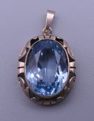 A 14 ct gold blue stone, possibly aquamarine pendant. 3 cm high. 9.4 grammes total weight.