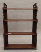 A Victorian walnut hanging shelf. 61.5 cm wide.