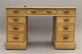 An Edwardian oak twin pedestal desk. 121 cm wide.