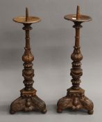 A pair of carved wooden pricket sticks. 56 cm high.