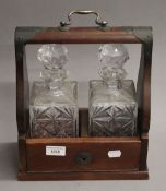 A two bottle tantalus. 26 cm wide.