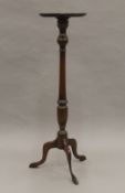 A modern mahogany torchere. 106.5 cm high.