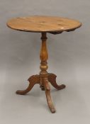 A tripod table with 19th century base and later top. 65 cm diameter.