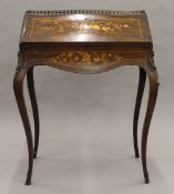A 19th century inlaid rosewood bonheur du jour. 70.5 cm wide.