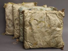 Four Chinese embroidered silk cushions. 43 x 46 cm.